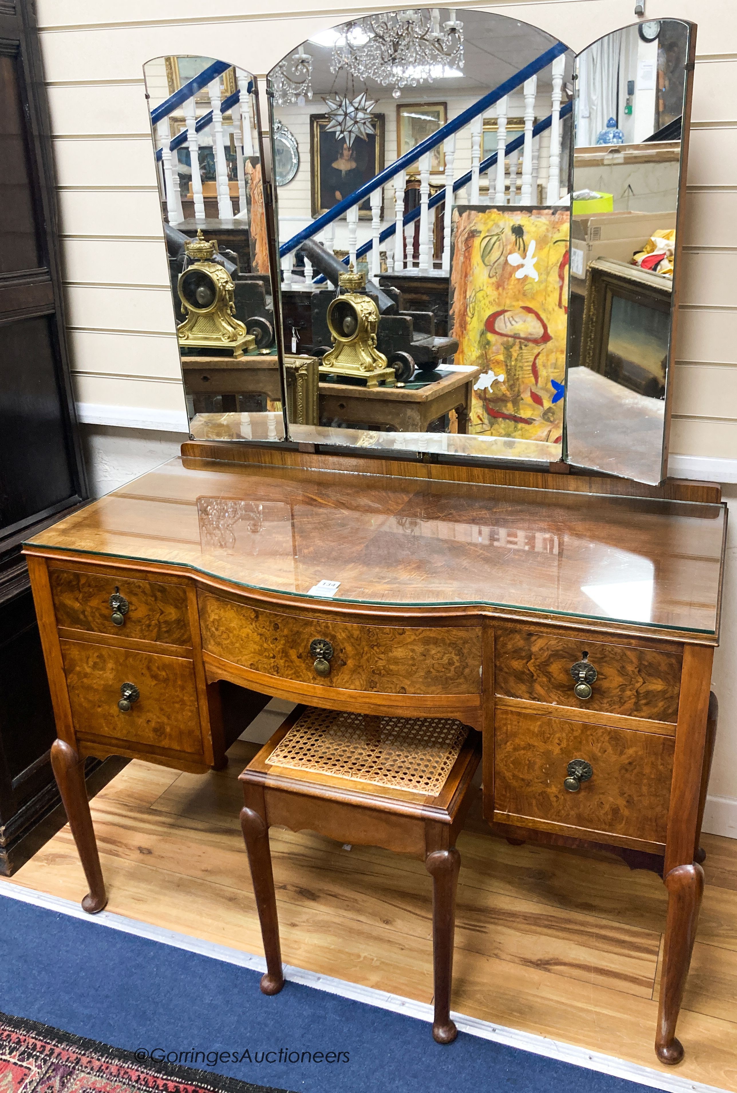 A 1930’s burr walnut dressing table, width 114cm, depth 52cm, height 160cm and a cane topped stool (2)